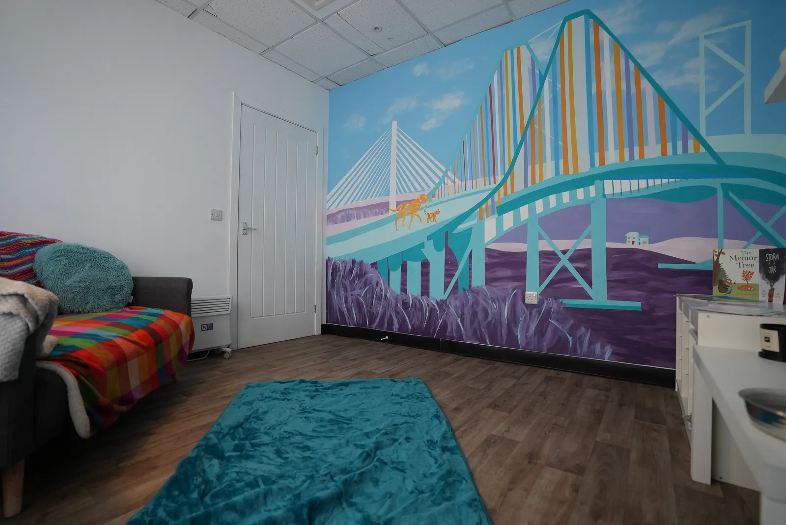 The Rainbow Room โ a private, homely space with the hand-painted Forth bridges mural and a soft sofa
