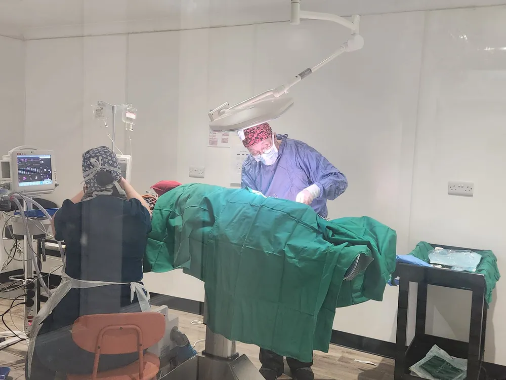 Inside the surgical theatre โ anaesthetic machine, patient monitor and a prepared operating table