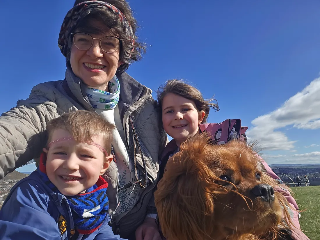 Dr Miriam Main, founder and veterinary surgeon, outdoors with her children and Clementine the spaniel